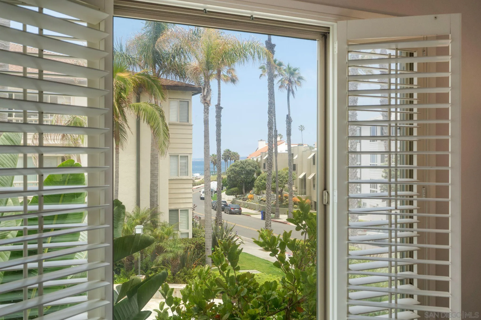 220 Coast Boulevard, Unit 2D La Jolla, CA 92037 - Photo 16 of 35 a view of a potted plant in front of a glass door