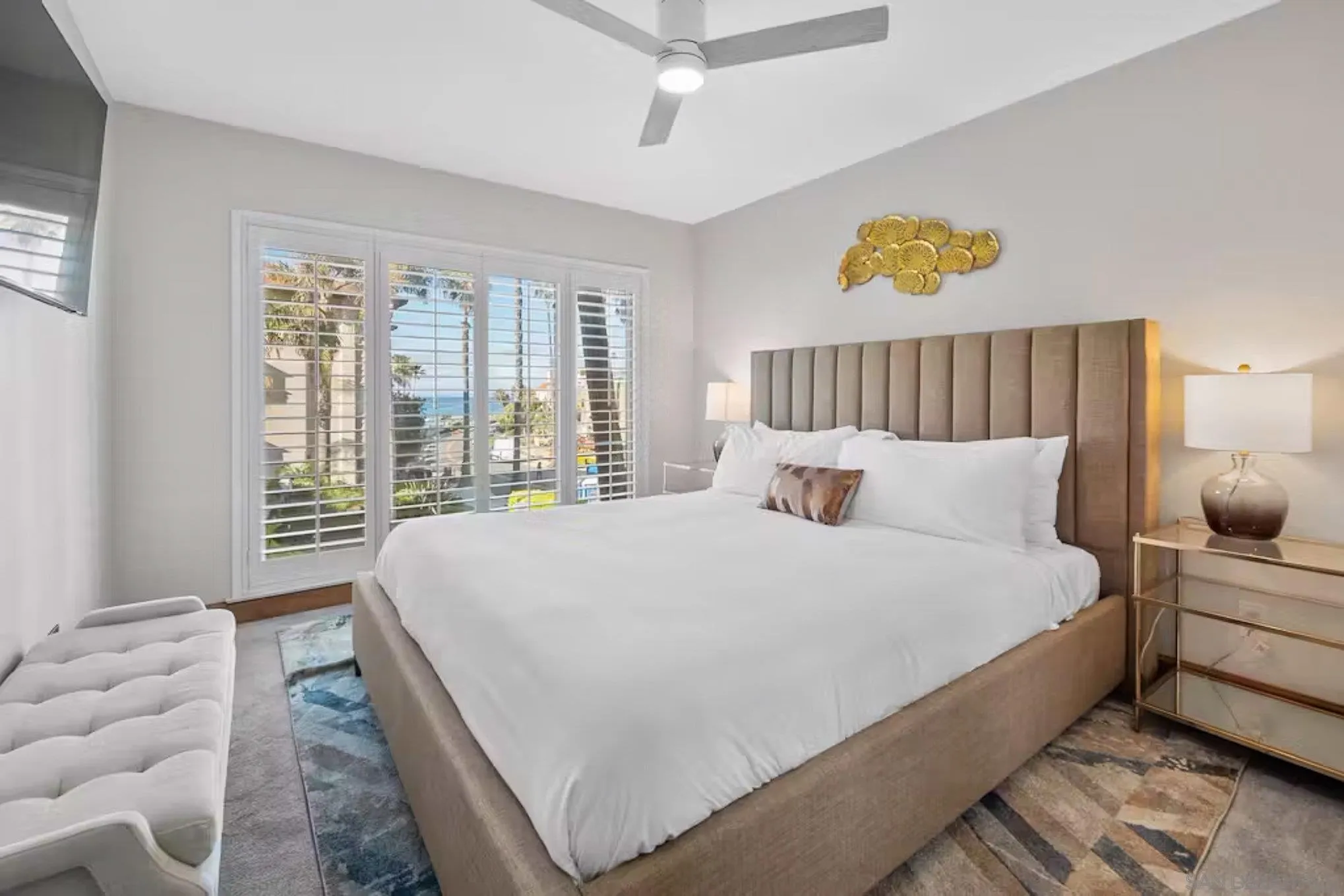220 Coast Boulevard, Unit 2D La Jolla, CA 92037 - Photo 18 of 35 a large bed sitting in a bedroom next to a window