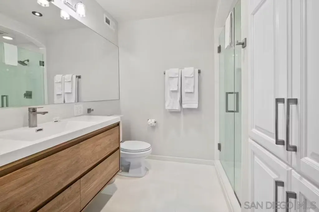 220 Coast Boulevard, Unit 2D La Jolla, CA 92037 - Photo 22 of 35 a bathroom with a double vanity sink toilet and shower