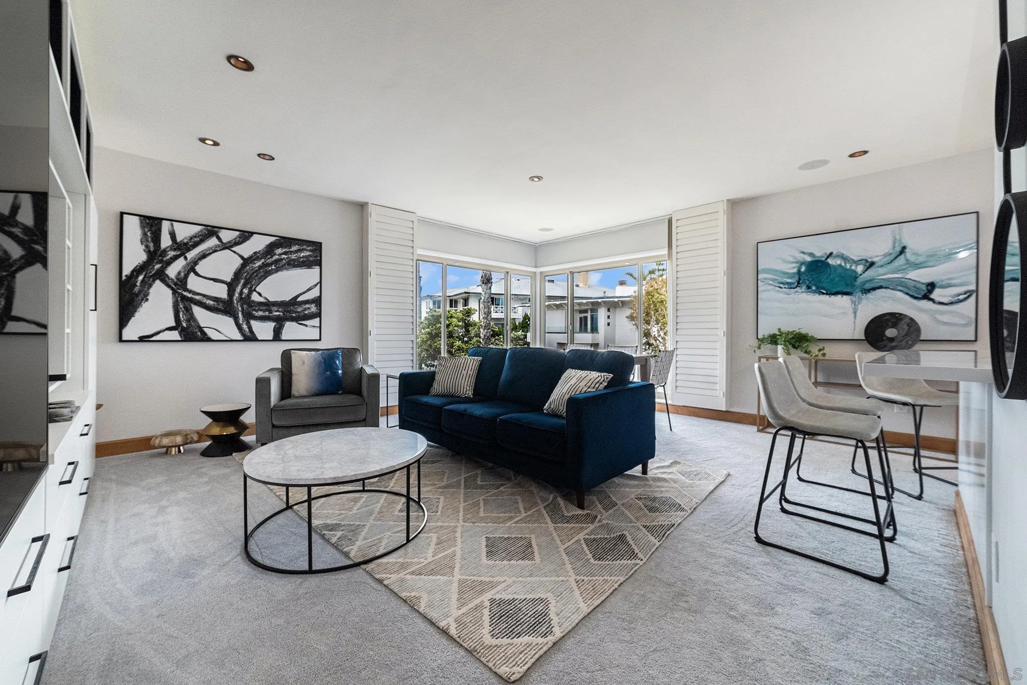 220 Coast Boulevard, Unit 2D La Jolla, CA 92037 - Photo 5 of 35 a living room with furniture a rug and white walls