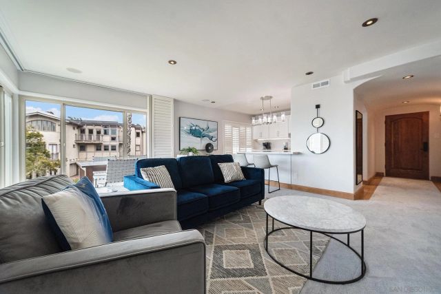 a living room with furniture a table and a large window