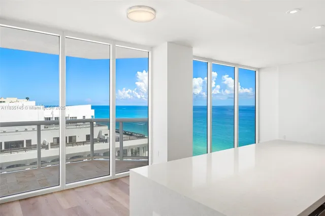 a view of an empty room with glass door