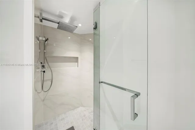 a bathroom with a glass shower door