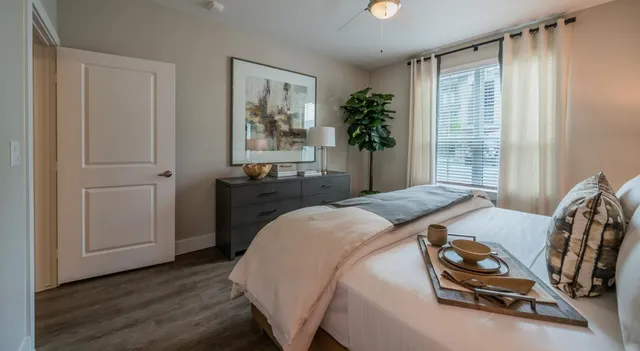 a bedroom with a bed and a potted plant