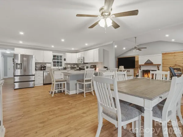 a dining room with furniture and wooden floor