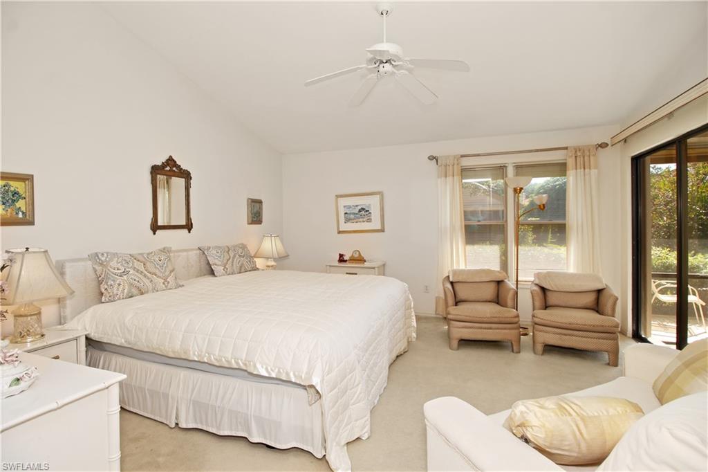 4028 Crayton Road, Unit C3 Naples, FL 34103 - Photo 15 of 32 a spacious bedroom with a bed and a couch