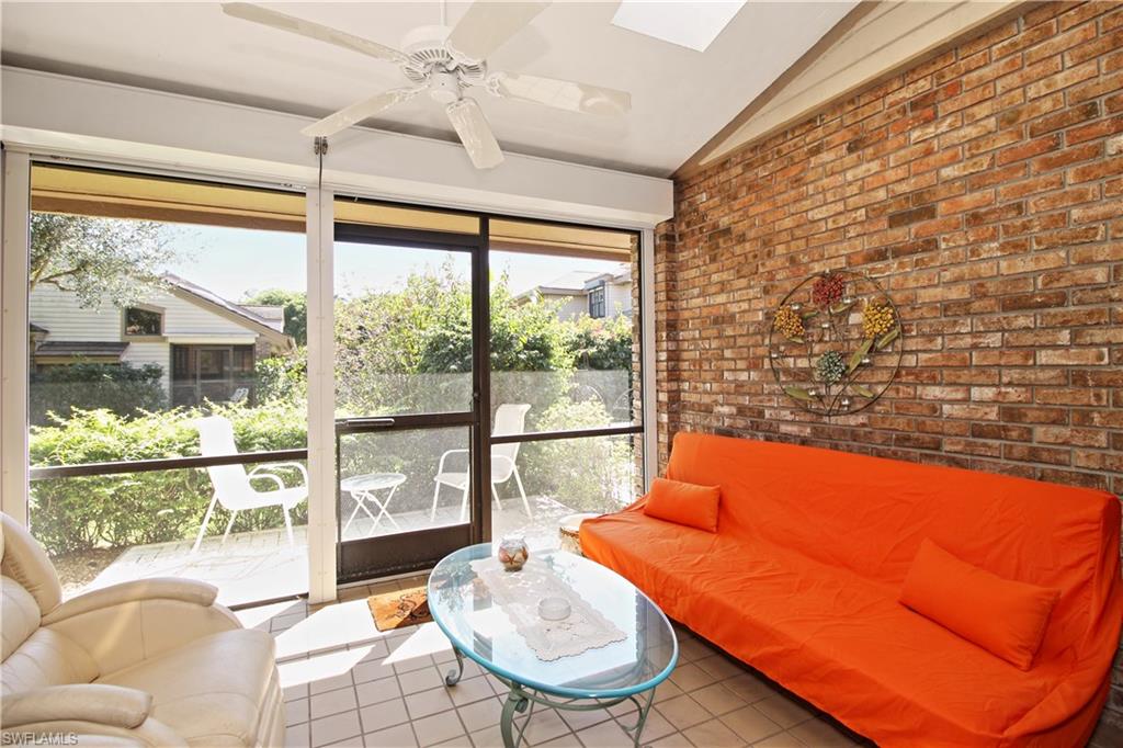 4028 Crayton Road, Unit C3 Naples, FL 34103 - Photo 18 of 32 a living room with blue couches and coffee table