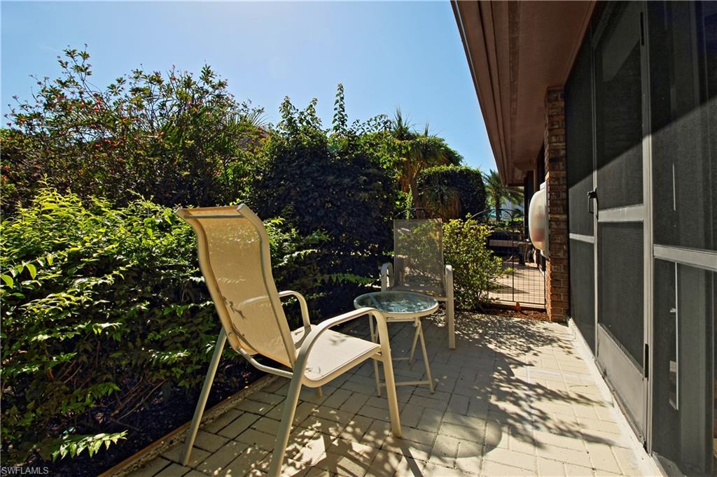 4028 Crayton Road, Unit C3 Naples, FL 34103 - Photo 19 of 32 a view of backyard with outdoor seating and plants