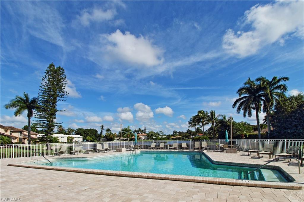 4028 Crayton Road, Unit C3 Naples, FL 34103 - Photo 24 of 32 a view of a swimming pool and lounge chairs