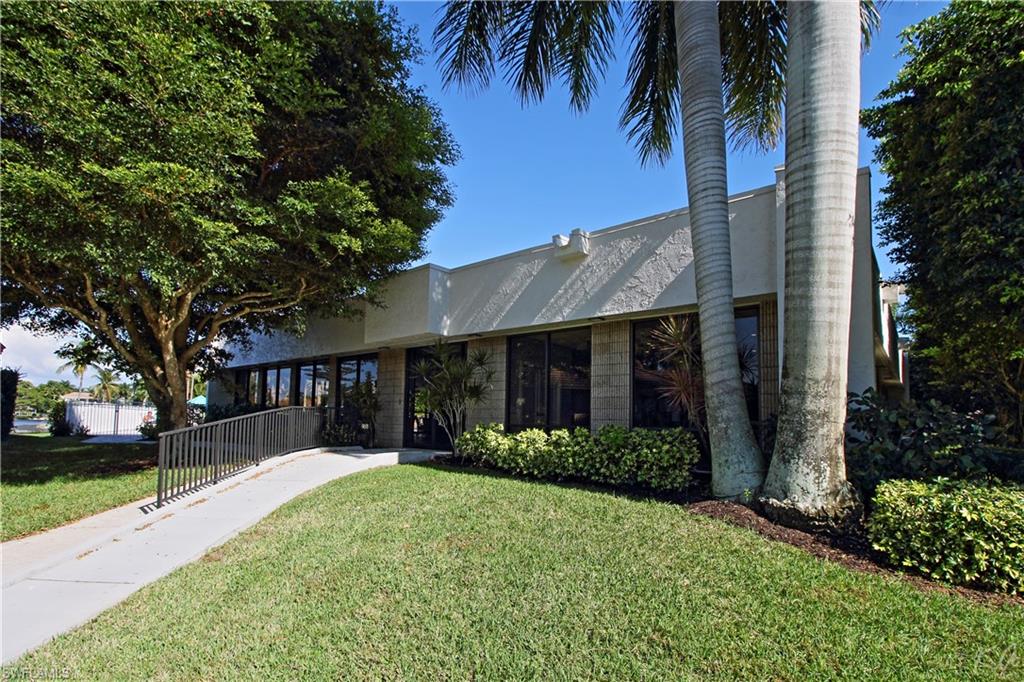 4028 Crayton Road, Unit C3 Naples, FL 34103 - Photo 25 of 32 a front view of house with a garden