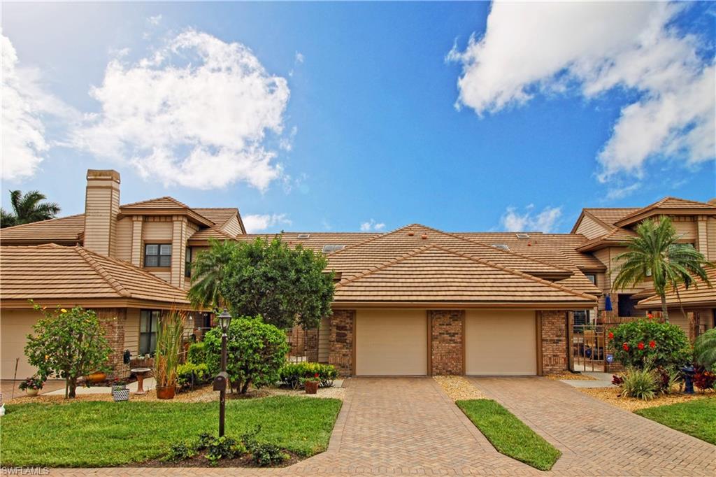 4028 Crayton Road, Unit C3 Naples, FL 34103 - Photo 3 of 32 a front view of a house with garden