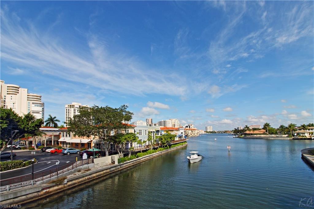 4028 Crayton Road, Unit C3 Naples, FL 34103 - Photo 31 of 32 a view of residential houses with outdoor space and lake view