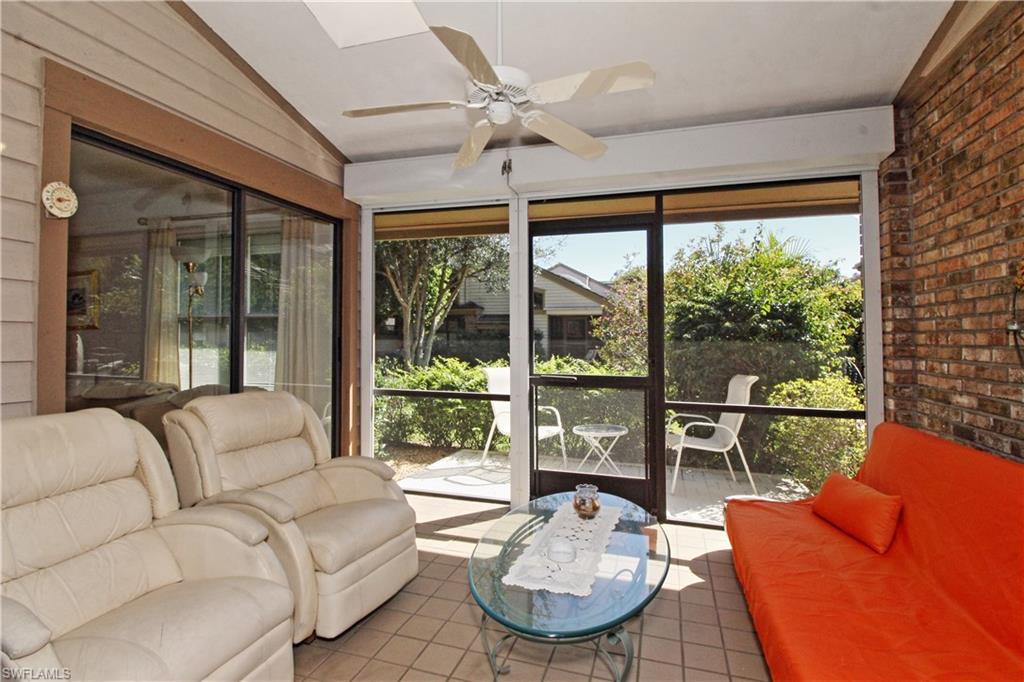4028 Crayton Road, Unit C3 Naples, FL 34103 - Photo 5 of 32 a living room with furniture a large window and a table