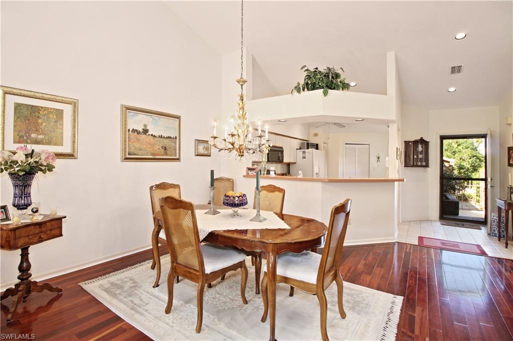 4028 Crayton Road, Unit C3 Naples, FL 34103 - Photo 7 of 32 a view of a dining room with furniture and wooden floor