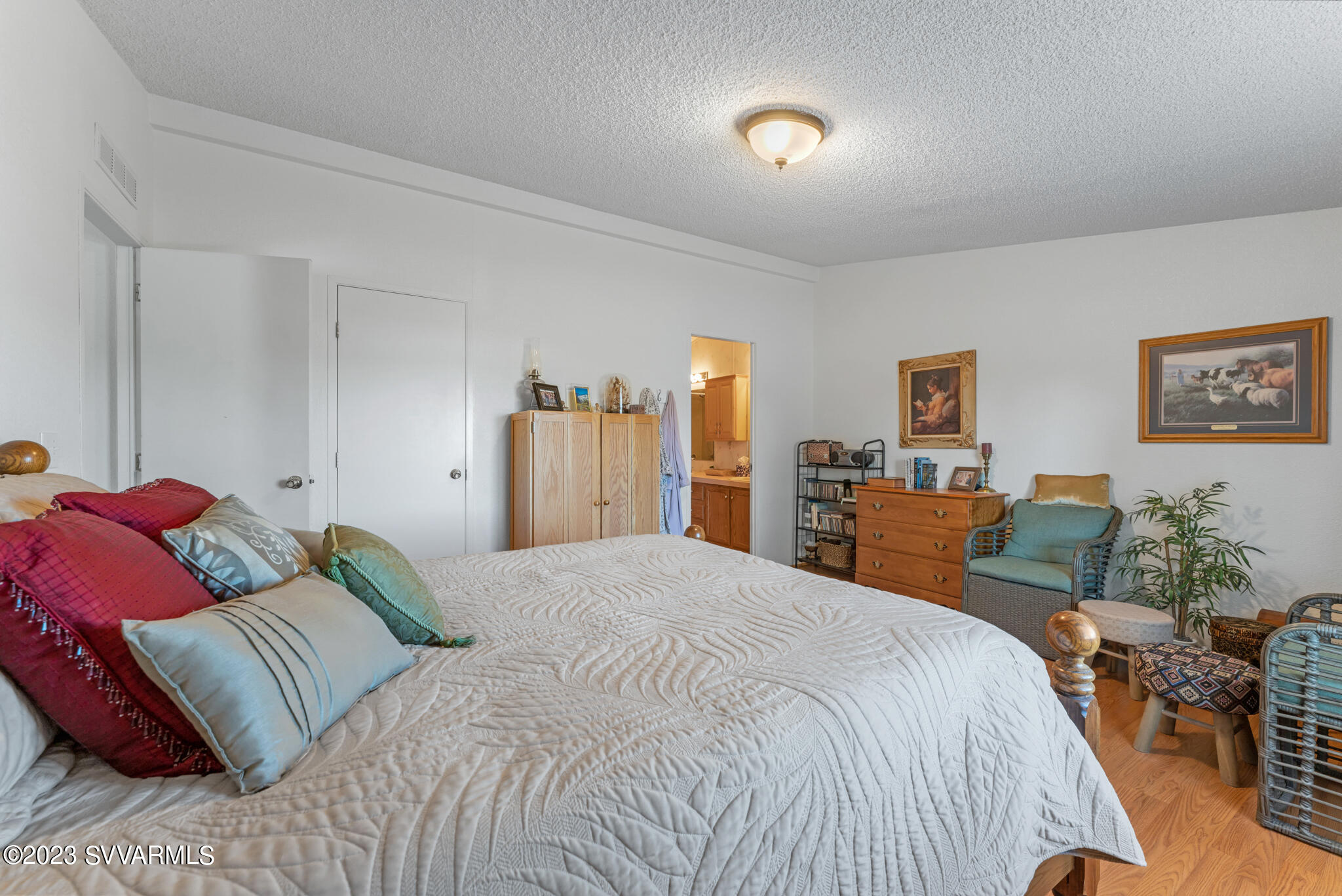 3730 East Beaver Creek Road Rimrock, AZ 86335 - Photo 30 of 49 a bedroom with a large bed and a chandelier