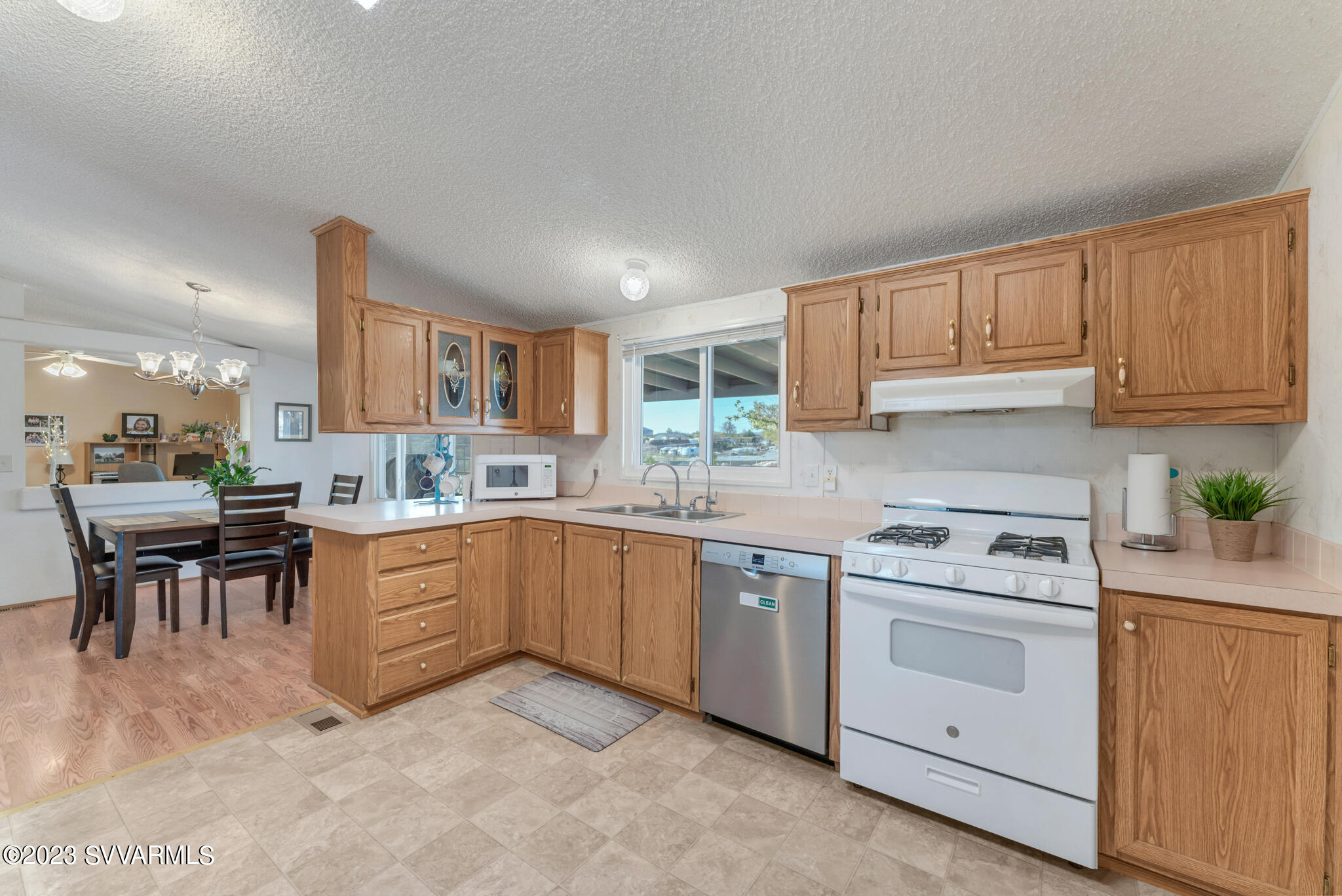 3730 East Beaver Creek Road Rimrock, AZ 86335 - Photo 46 of 49 a kitchen with white cabinets and white appliances