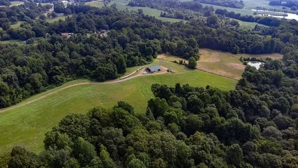 an aerial view of a house with a yard