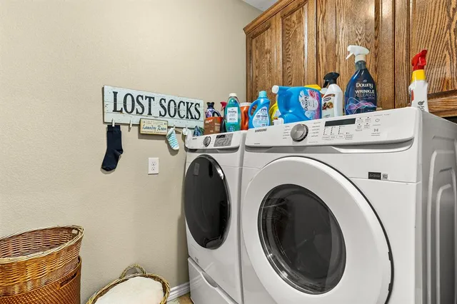 a bed sitting in a bedroom next to a window and a chandelier