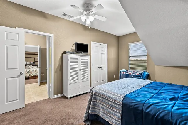 a view of a house with a bench in a patio