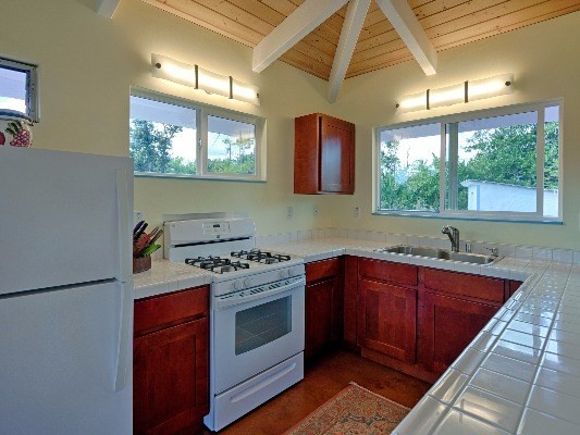 14-4825 La Maloo Road Pahoa, HI 96778 - Photo 14 of 25 a kitchen with a stove a sink and a window