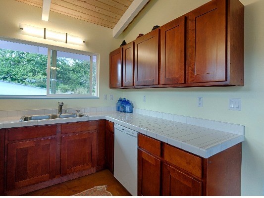 14-4825 La Maloo Road Pahoa, HI 96778 - Photo 15 of 25 a kitchen with stainless steel appliances granite countertop wooden cabinets a sink and dishwasher