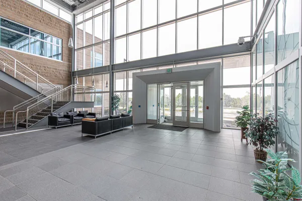 a lobby with furniture and floor to ceiling windows