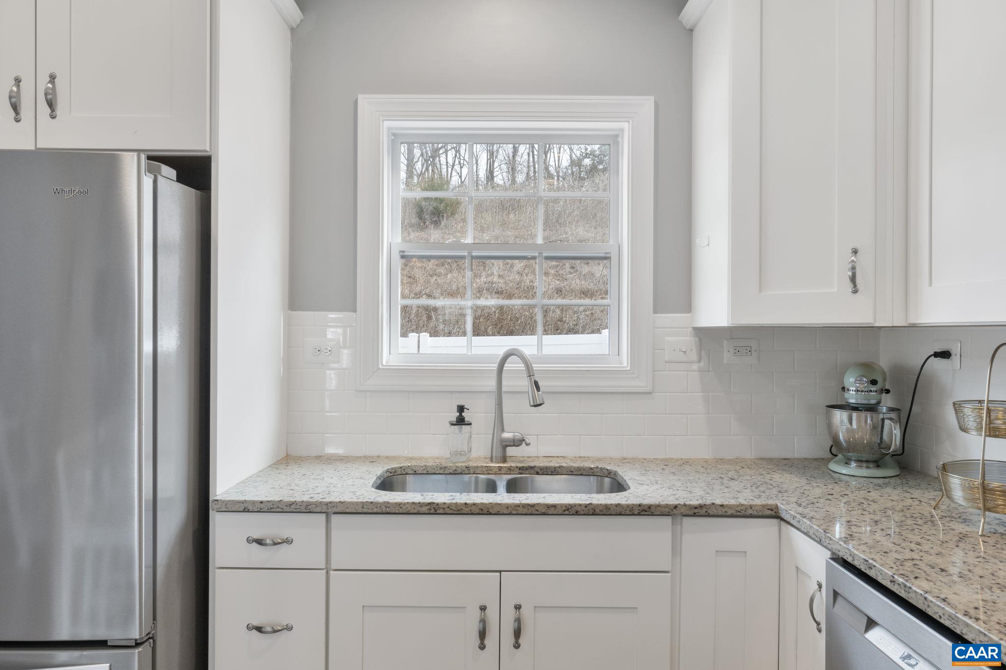 2424 Winthrop Drive Charlottesville, VA 22911 - Photo 12 of 36 a kitchen with granite countertop a sink and a window