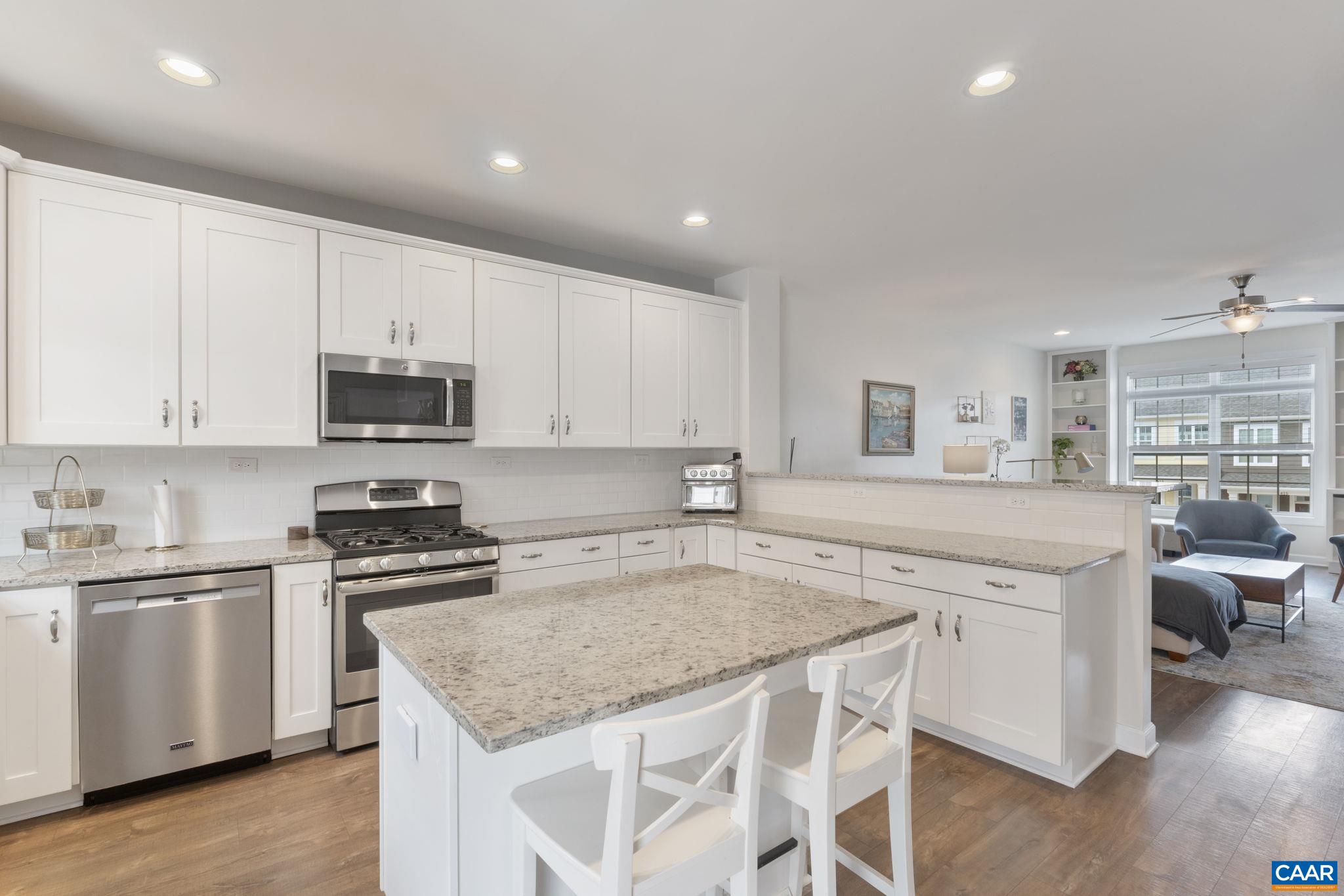2424 Winthrop Drive Charlottesville, VA 22911 - Photo 13 of 36 a kitchen with stainless steel appliances granite countertop a stove top oven a sink a refrigerator and white cabinets with wooden floor