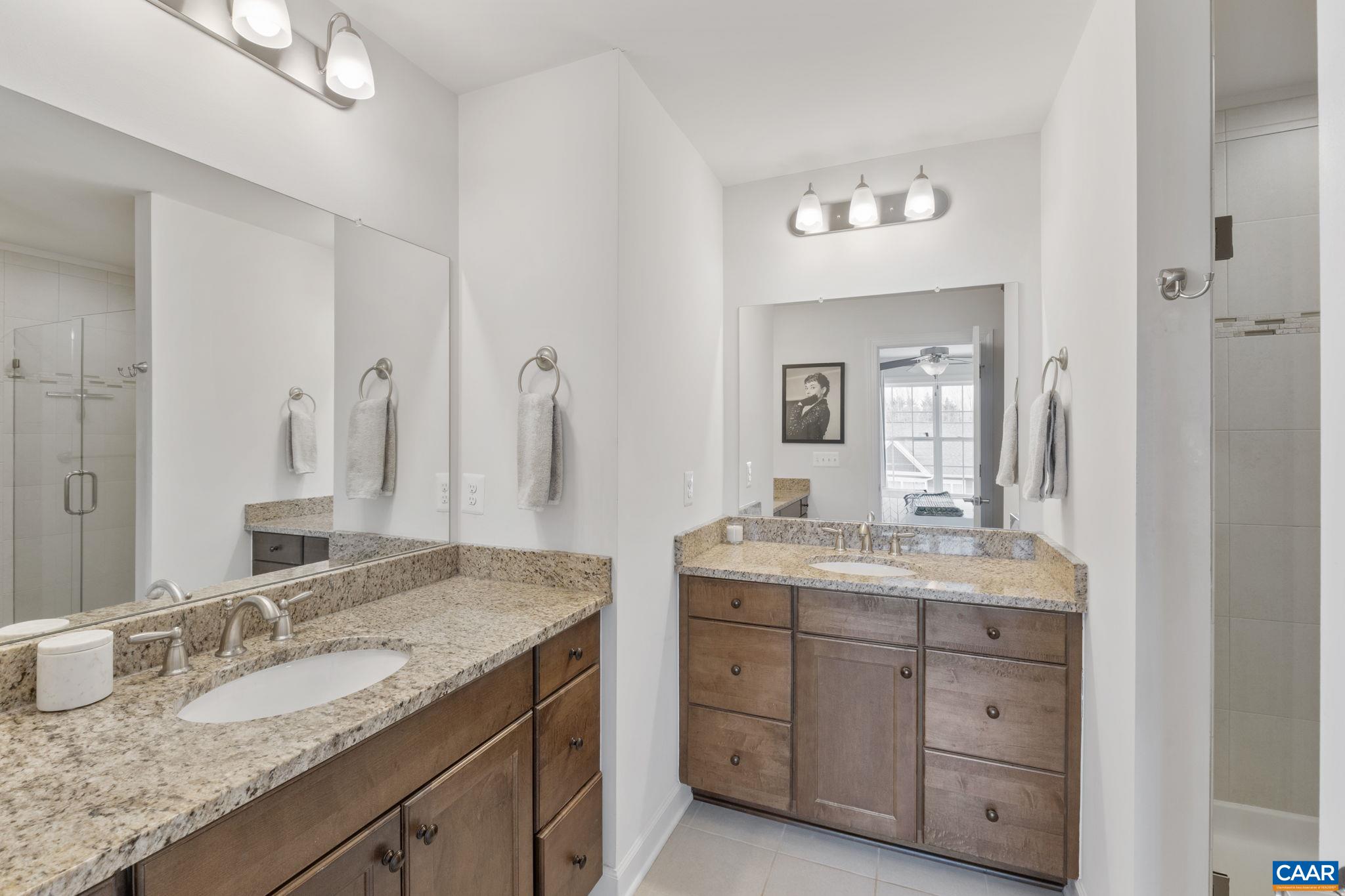 2424 Winthrop Drive Charlottesville, VA 22911 - Photo 19 of 36 a bathroom with a granite countertop double vanity sink and mirror