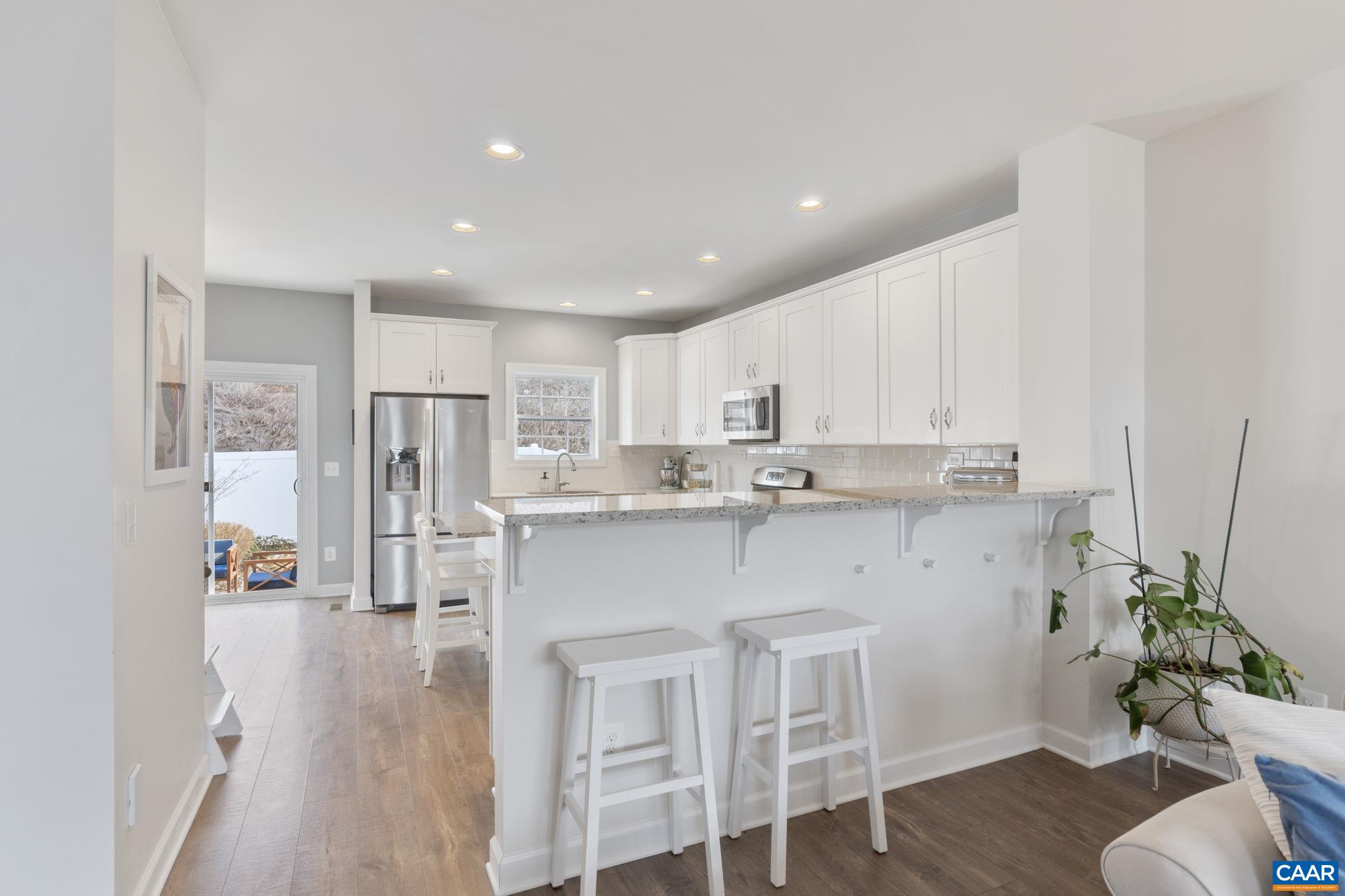 2424 Winthrop Drive Charlottesville, VA 22911 - Photo 10 of 36 a kitchen with stainless steel appliances kitchen island granite countertop a refrigerator and a sink