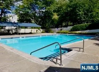 swimming pool view with a seating space