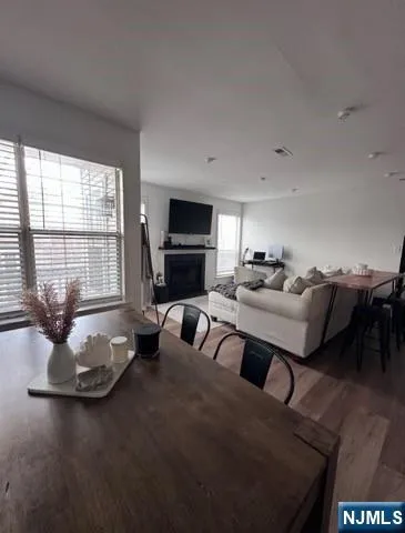 a living room with furniture fireplace and large windows