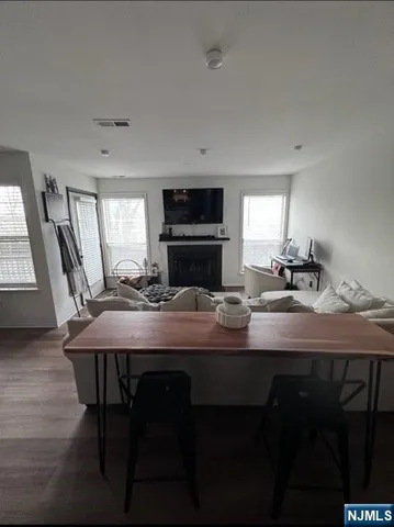 a kitchen with a table chairs a sink dishwasher refrigerator and cabinets