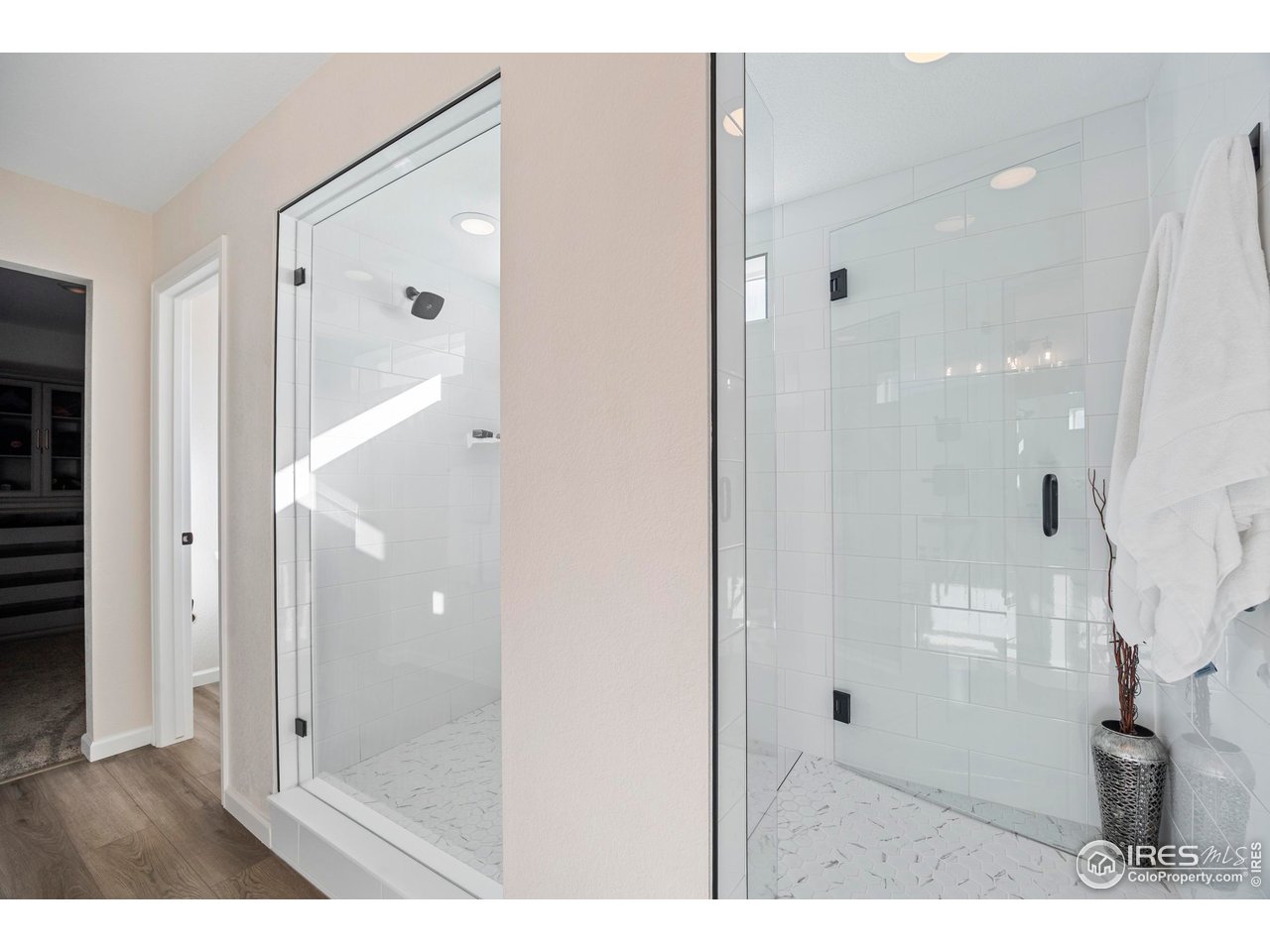 951 Rustling Street Windsor, CO 80550 - Photo 20 of 47 a bathroom with a glass shower door