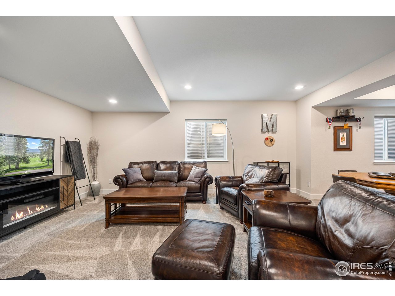 951 Rustling Street Windsor, CO 80550 - Photo 27 of 47 a living room with furniture and a flat screen tv