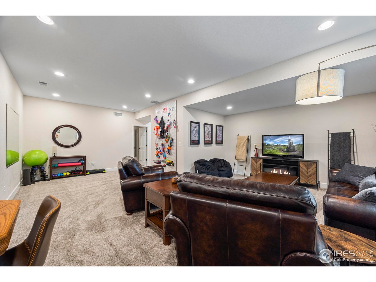 951 Rustling Street Windsor, CO 80550 - Photo 29 of 47 a living room with furniture and a flat screen tv