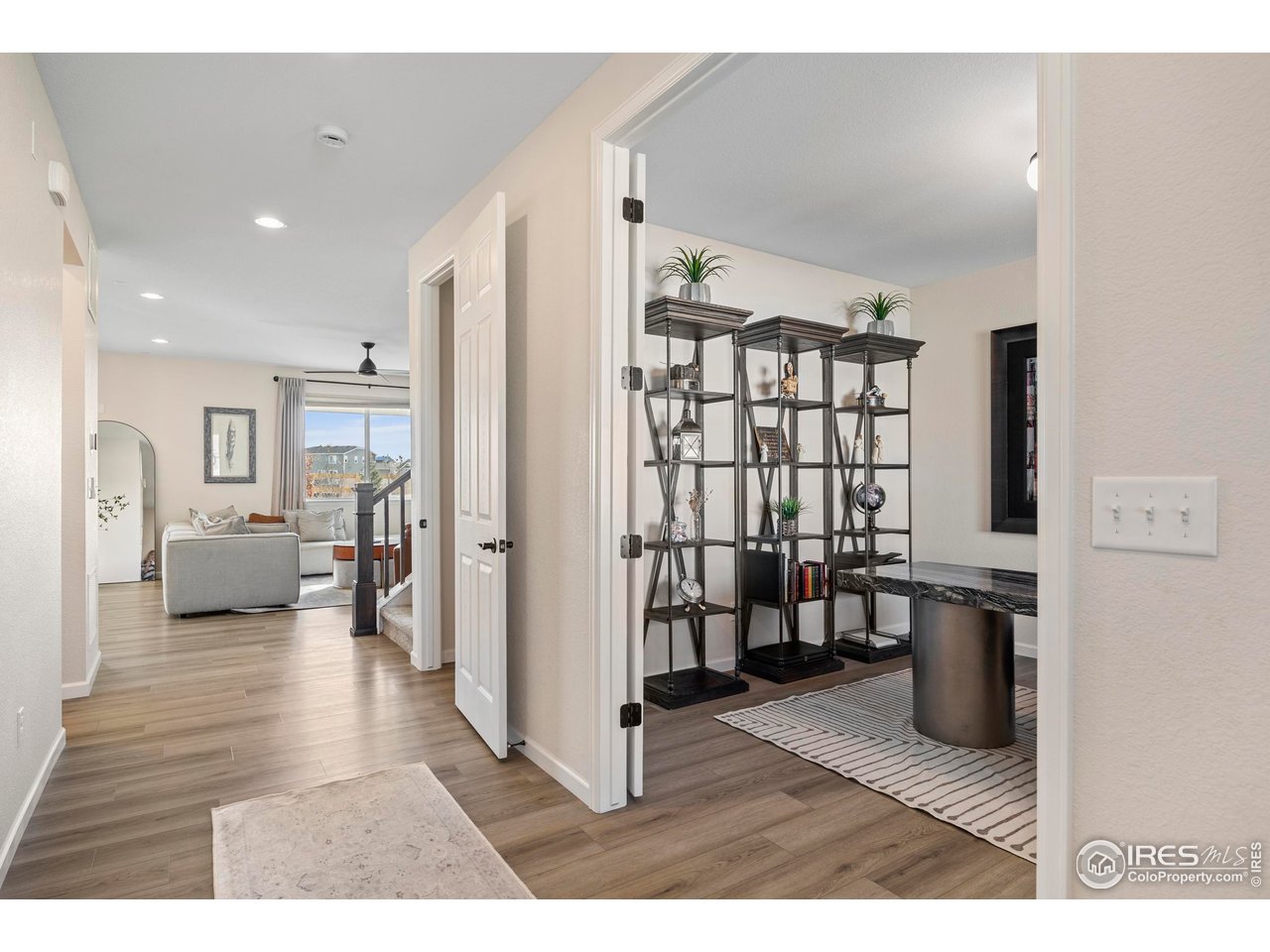 951 Rustling Street Windsor, CO 80550 - Photo 3 of 47 a living room with furniture and a wooden floor