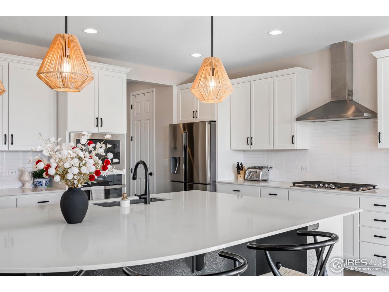 951 Rustling Street Windsor, CO 80550 - Photo 7 of 47 a kitchen with a sink a counter and cabinets