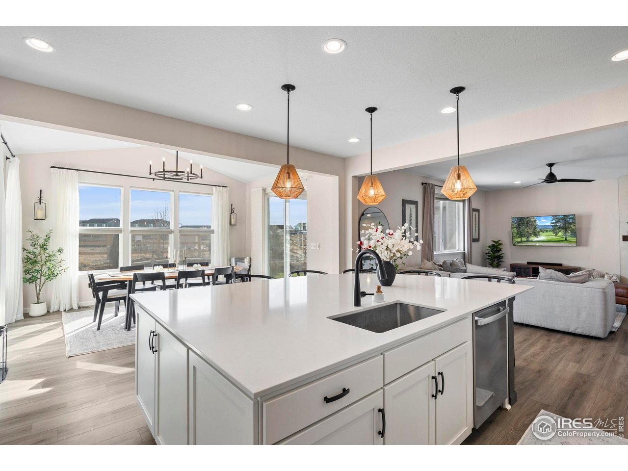 951 Rustling Street Windsor, CO 80550 - Photo 10 of 47 a kitchen with counter top space appliances and living room view
