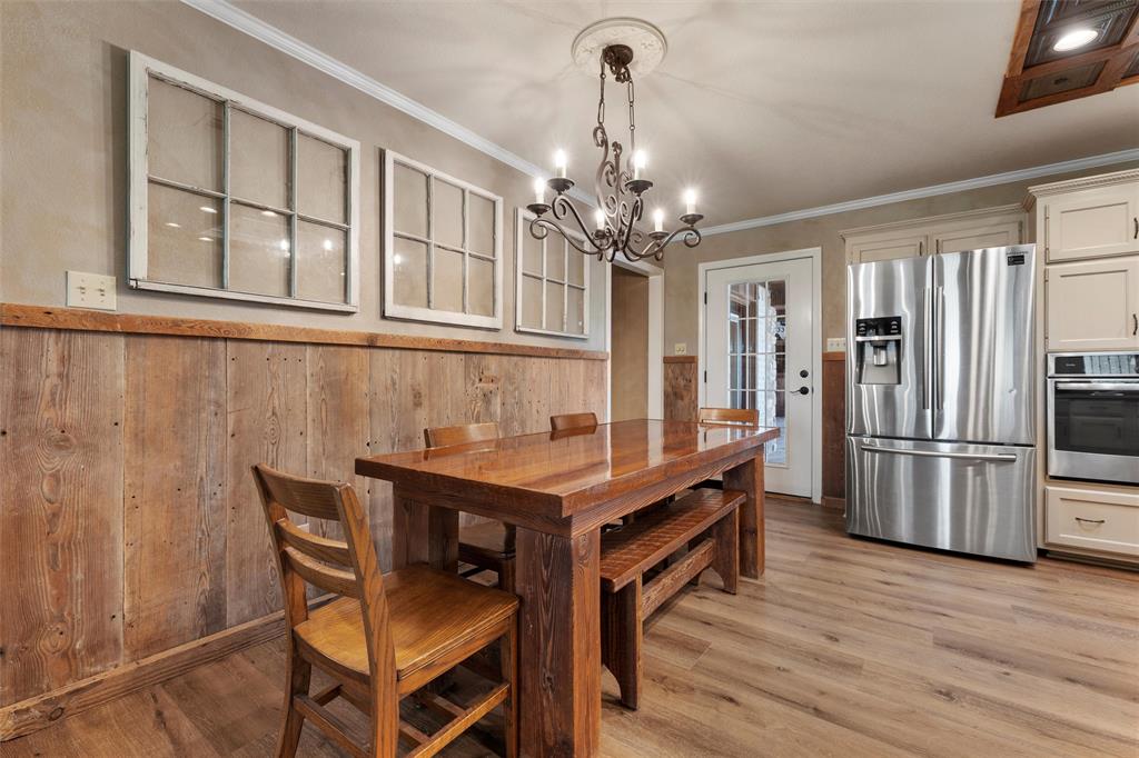 3057 Holy Road Abbott, TX 76621 - Photo 20 of 39 a dining room with furniture a chandelier and wooden floor