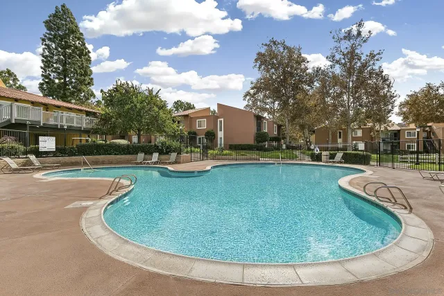 a view of a house with swimming pool and yard