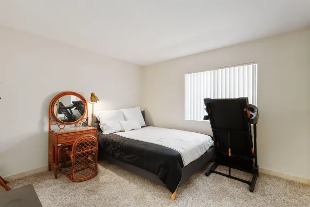 a bedroom with a bed and a chair