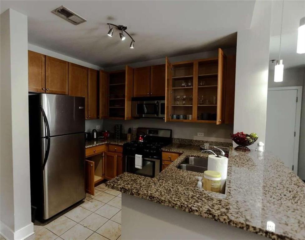 a kitchen with refrigerator and cabinets