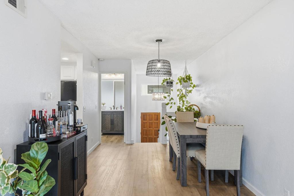3711 Balboa Terrace, Unit B San Diego, CA 92117 - Photo 18 of 39 a dining room with furniture and a chandelier