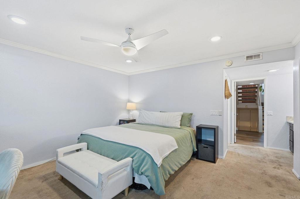 3711 Balboa Terrace, Unit B San Diego, CA 92117 - Photo 24 of 39 a bedroom with a bed and a chandelier