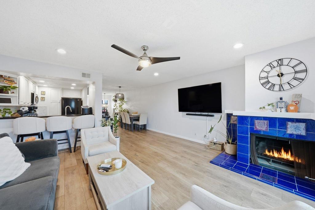 3711 Balboa Terrace, Unit B San Diego, CA 92117 - Photo 3 of 39 a living room with furniture a flat screen tv and a fireplace