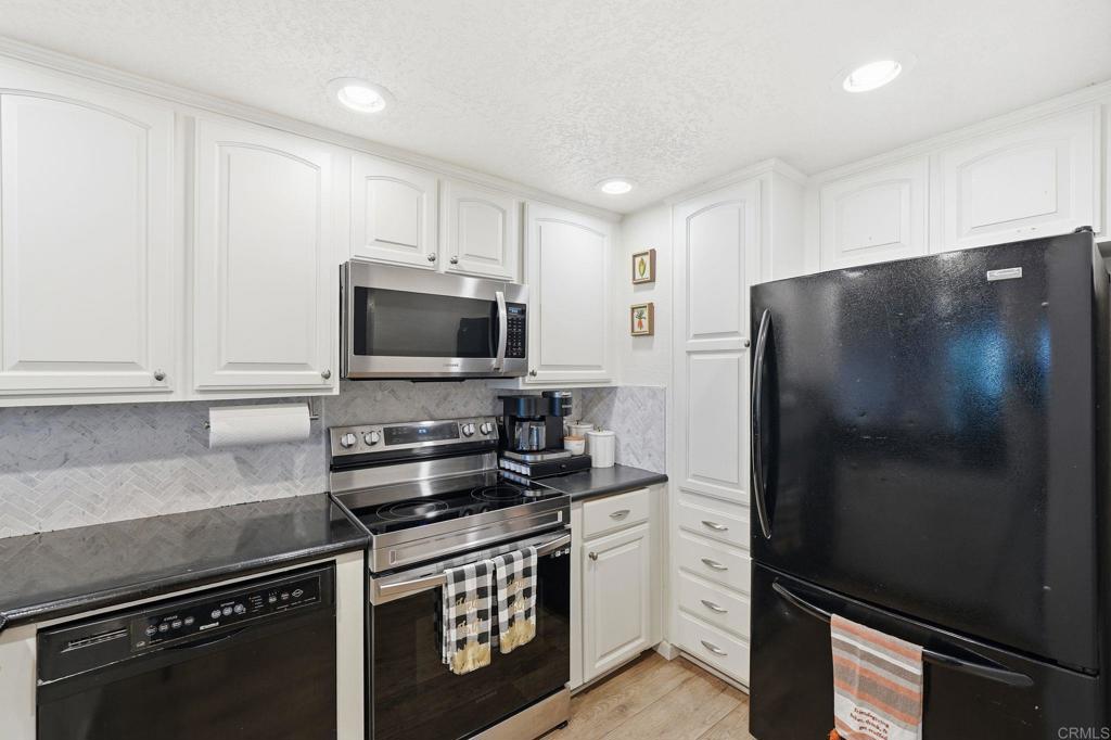 3711 Balboa Terrace, Unit B San Diego, CA 92117 - Photo 10 of 39 a kitchen with a refrigerator stove and microwave