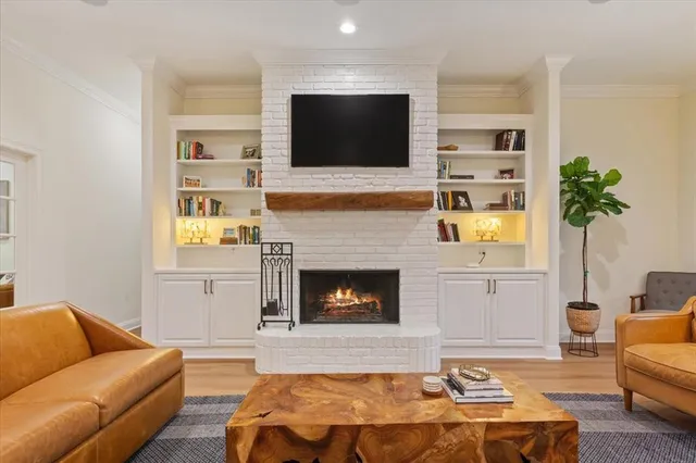 a living room with furniture fireplace and flat screen tv