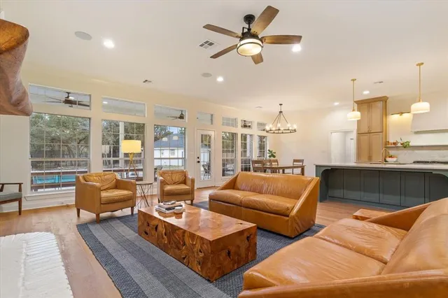 a living room with furniture kitchen view and a large window