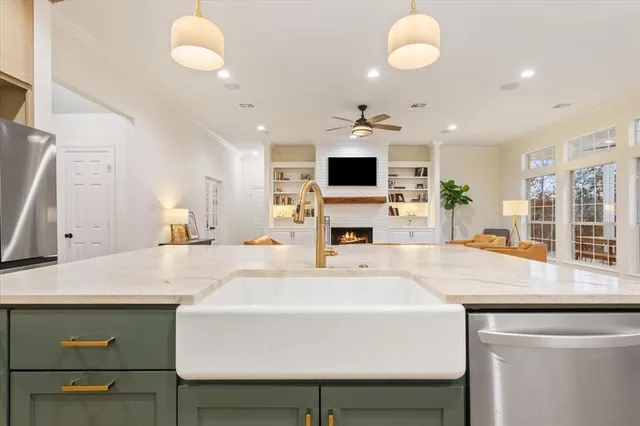 a kitchen with a table chairs sink and microwave